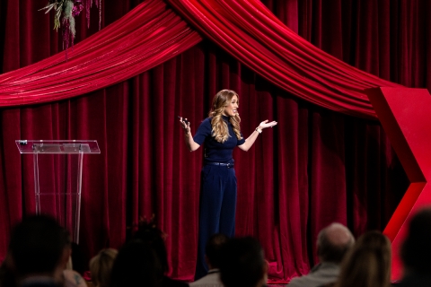 speaker on stage wearing blue