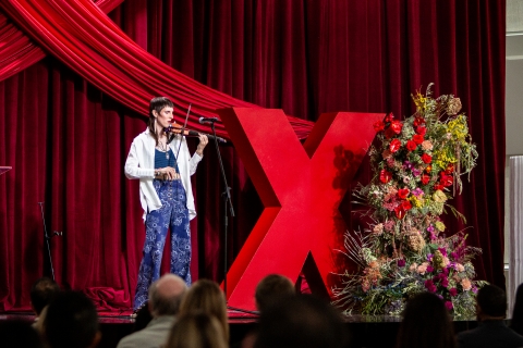 speaker on stage with violin