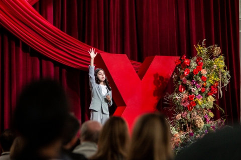 speaker with arms up