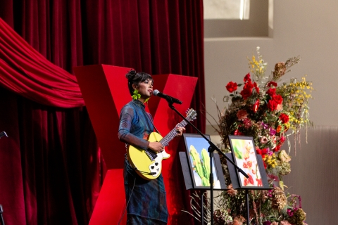 speaker on stage with guitar
